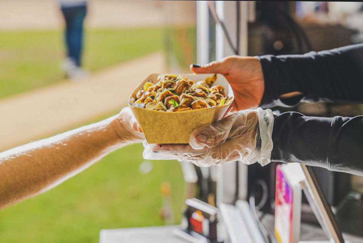 A Punjabi Bytes order being handed to a customer at the food trailer