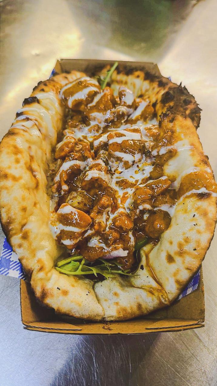 A cheesy naan taco filled with Punjabi curry from the Punjabi Bytes trailer